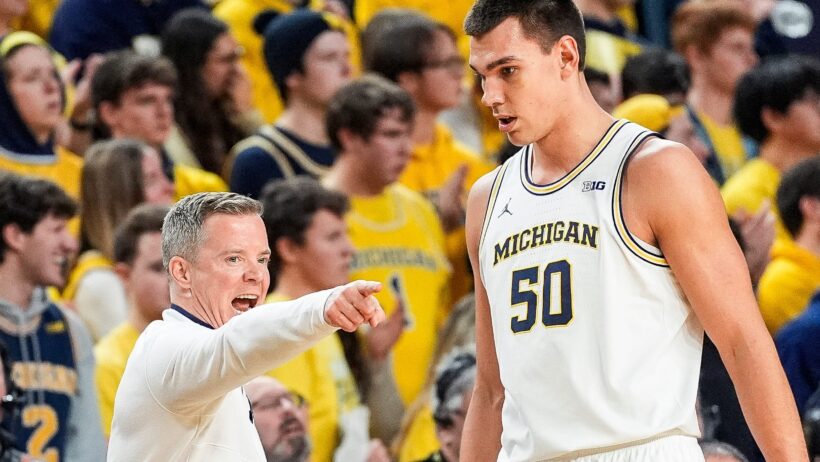 Michigan head coach talking to center Vladislav Goldin