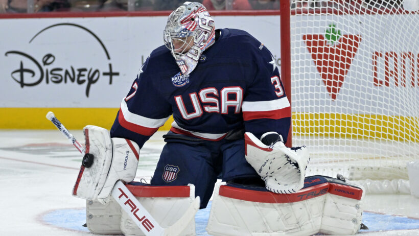 Team United States goalie Connor Hellebuyck makes a blocker save against Team Canada