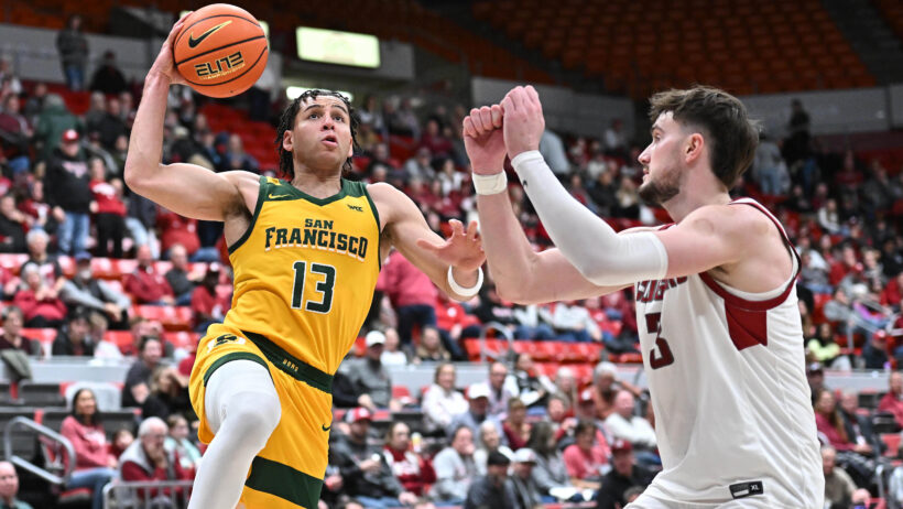 San Francisco Dons guard Robby Beasley goes for a layup against Washington State Cougars forward Ethan Price