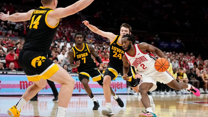 Ohio State Buckeyes guard Bruce Thornton dribbling through Iowa Hawkeye defenders