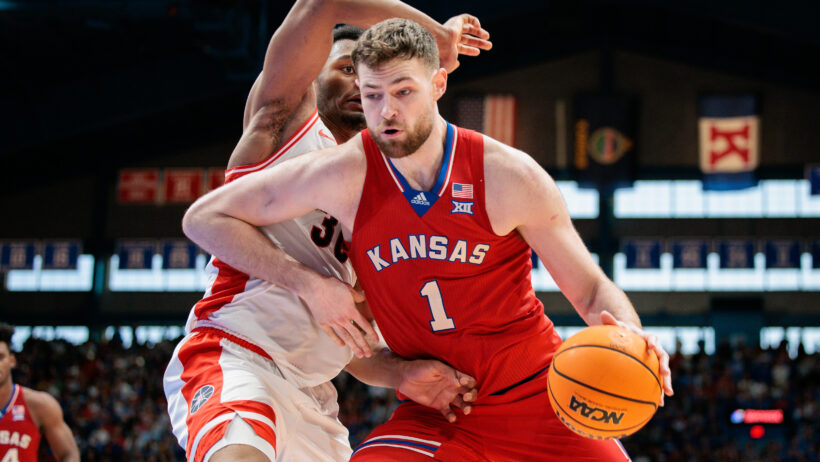 Kansas Jayhawks center Hunter Dickinson spins off an Arizona defender