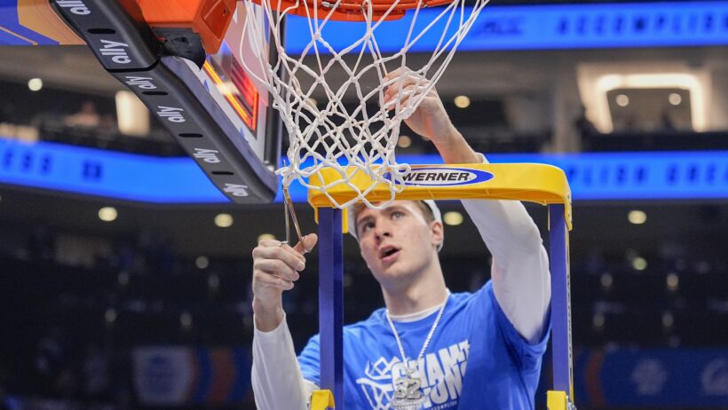 Duke Blue Devils forward Cooper Flagg cutting down the nets after his team won the 2025 ACC Tournament