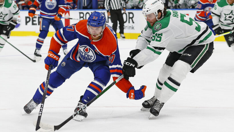 Edmonton Oilers forward Connor McDavid (97) carries the puck around Dallas Stars defensemen Thomas Harley