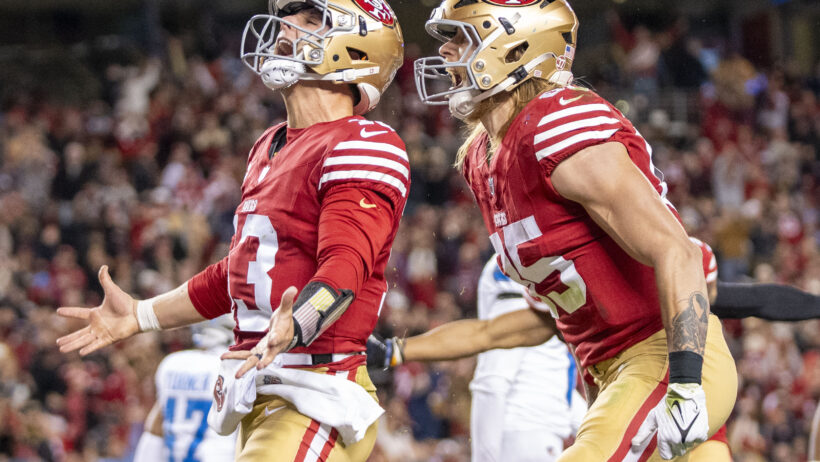 Brock Purdy and George Kittle celebrate a 49ers touchdown.