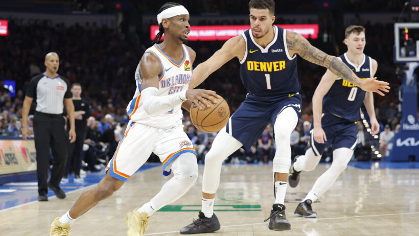 Oklahoma City Thunder guard Shai Gilgeous-Alexander drives to the basket as Denver Nuggets forward Michael Porter Jr defends