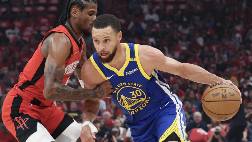 Golden State Warriors guard Stephen Curry tries to drive past Houston Rockets guard Jalen Green