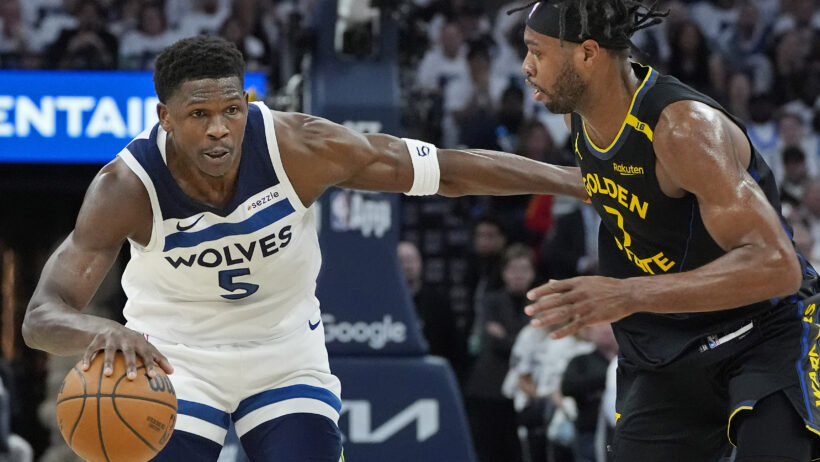 Minnesota Timberwolves guard Anthony Edwards dribbles as Golden State Warriors forward Buddy Hield defends