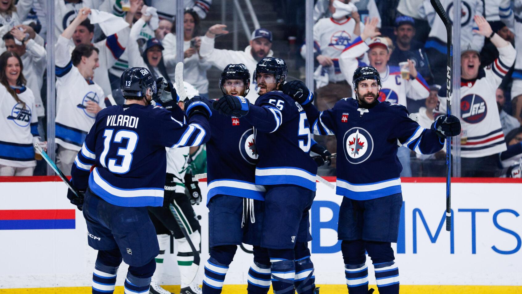 Mark Scheifele and his teammates celebrate a goal.