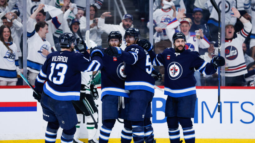 Mark Scheifele and his teammates celebrate a goal.