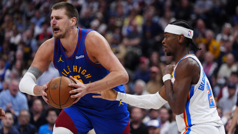 Oklahoma City Thunder guard Shai Gilgeous-Alexander defends on Denver Nuggets center Nikola Jokic