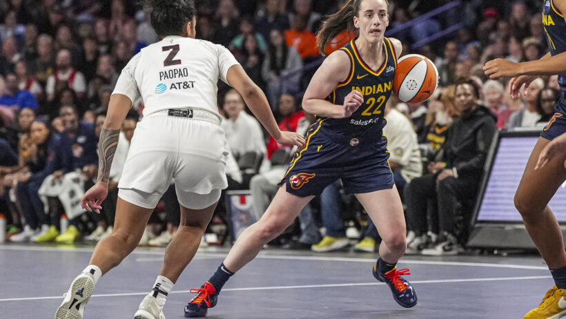 Indiana Fever guard Caitlin Clark controls the ball against the Atlanta Dream