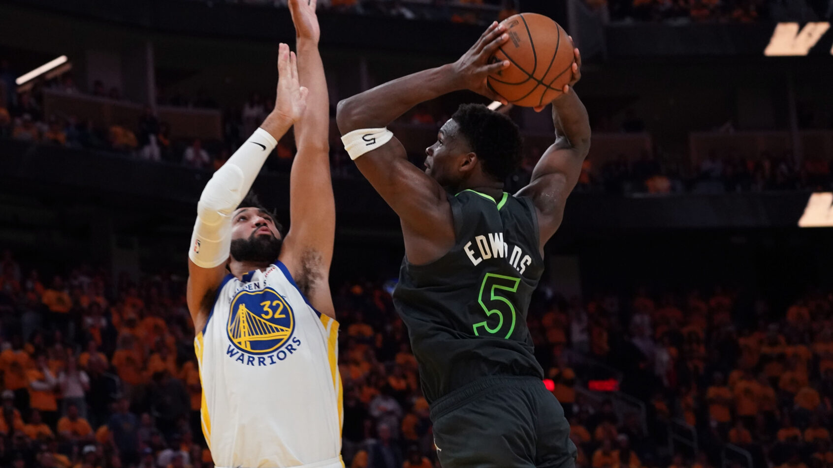 Minnesota Timberwolves guard Anthony Edwards dunking on over Golden State Warriors forward Trayce Jackson-Davis
