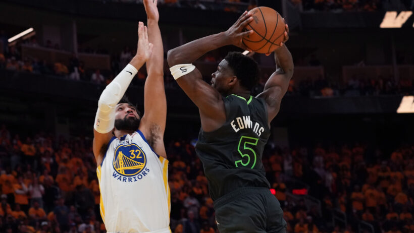 Minnesota Timberwolves guard Anthony Edwards dunking on over Golden State Warriors forward Trayce Jackson-Davis