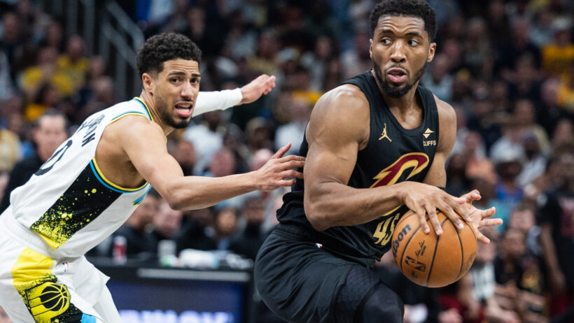 Cleveland Cavaliers guard Donovan Mitchell holds the ball while Indiana Pacers guard Tyrese Haliburton defends