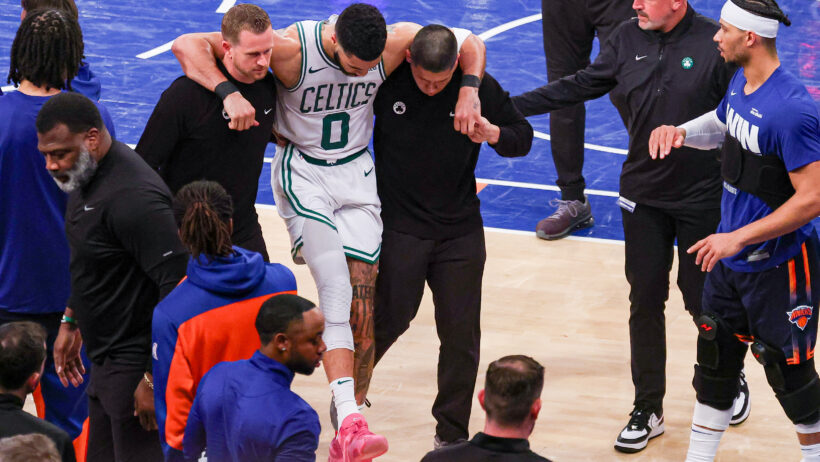 Boston Celtics forward Jayson Tatum being carried off the court