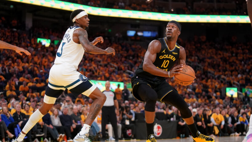 Golden State Warriors forward Jimmy Butler III holds the ball while Minnesota Timberwolves forward Jaden McDaniels