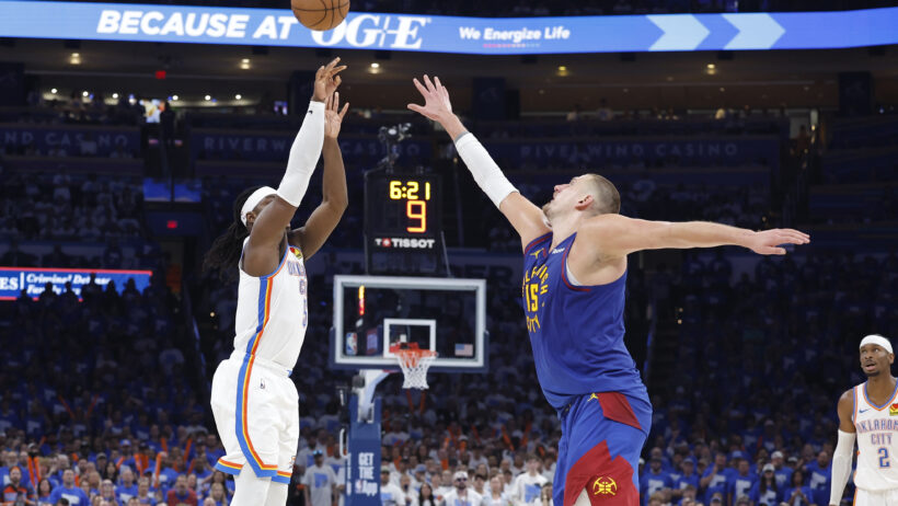 Luguentz Dort fires a three-point attempt over Nikola Jokic's outstretched fingertips.