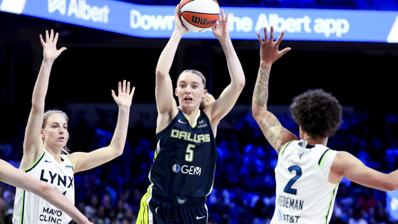 Dallas Wings guard Paige Bueckers looks to pass against the Minnesota Lynx
