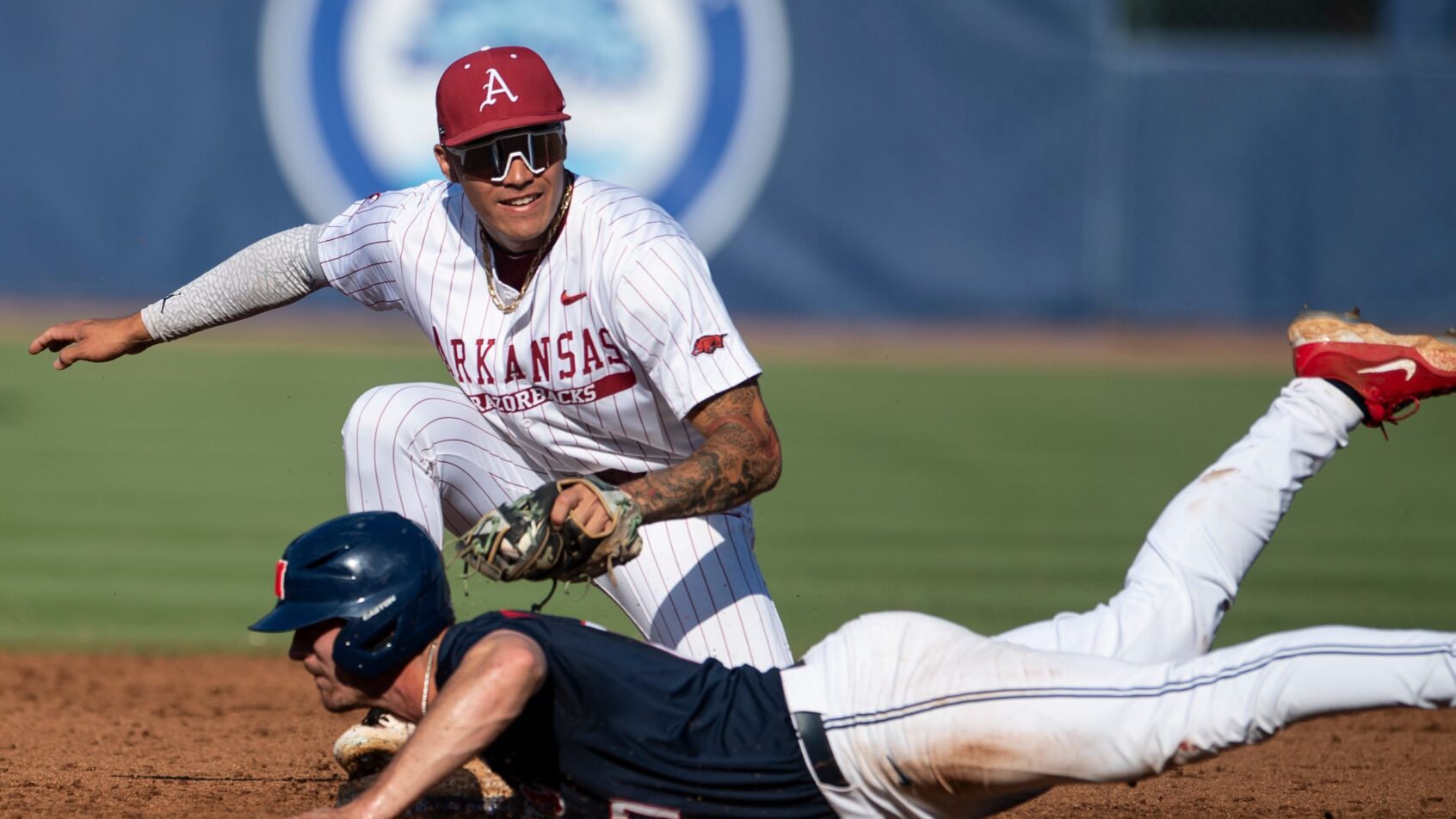 Arkansas Razorbacks' Wehiwa Aloy tagging out Ole Miss Rebels' Judd Utermark at second base