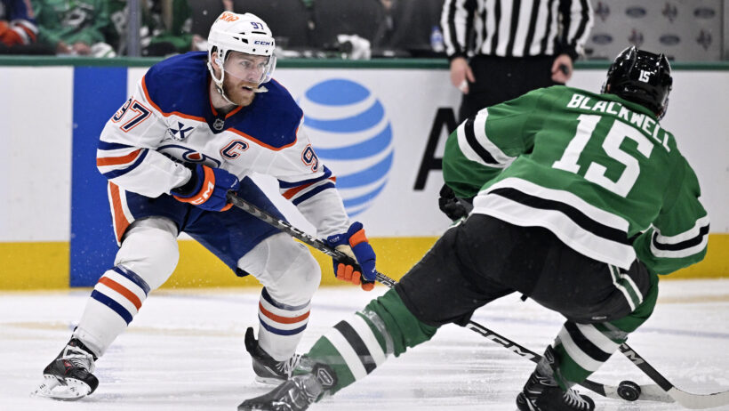 Edmonton Oilers center Connor McDavid skates with the puck past Dallas Stars center Colin Blackwell