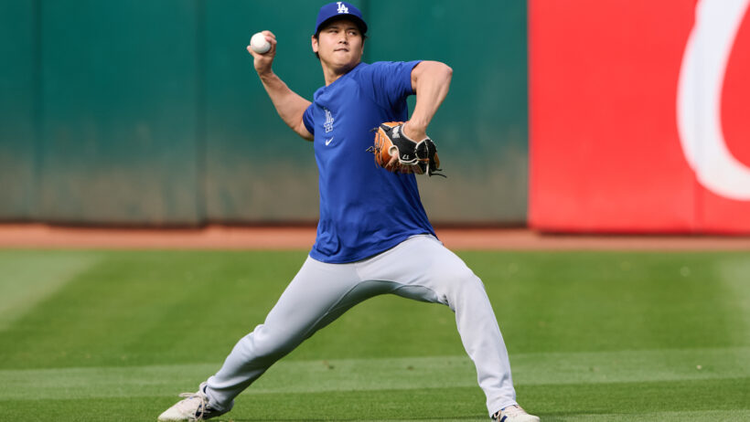 Los Angeles Dodgers designated hitter Shohei Ohtani throwing a ball during warmups