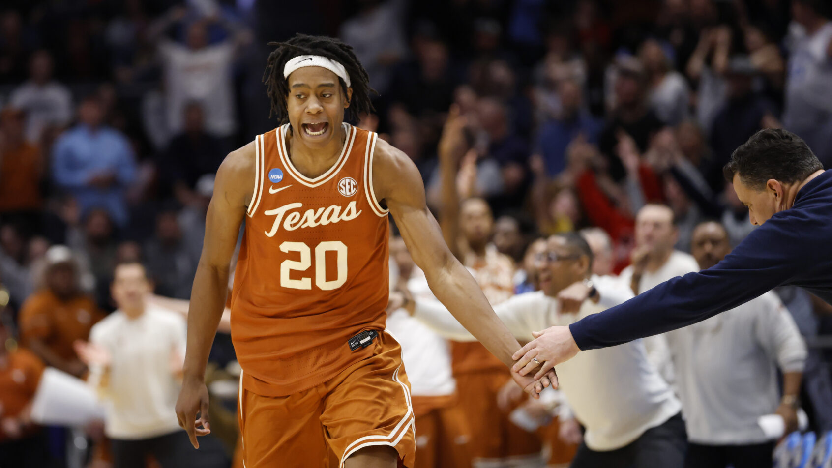 Texas Longhorns guard Tre Johnson high fiving a coach