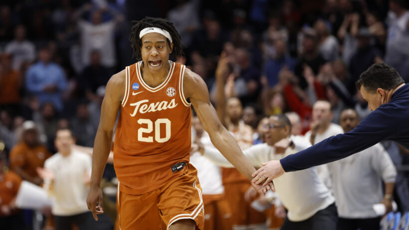 Texas Longhorns guard Tre Johnson high fiving a coach