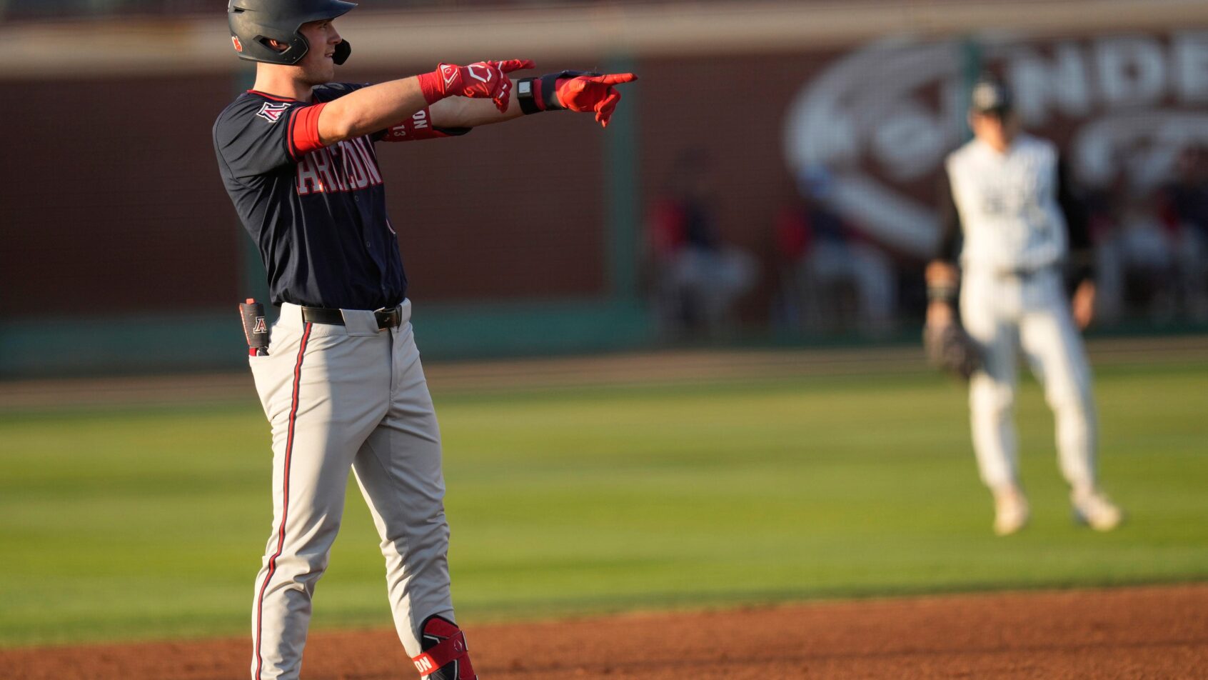 Aaron Walton points at dugout from second base