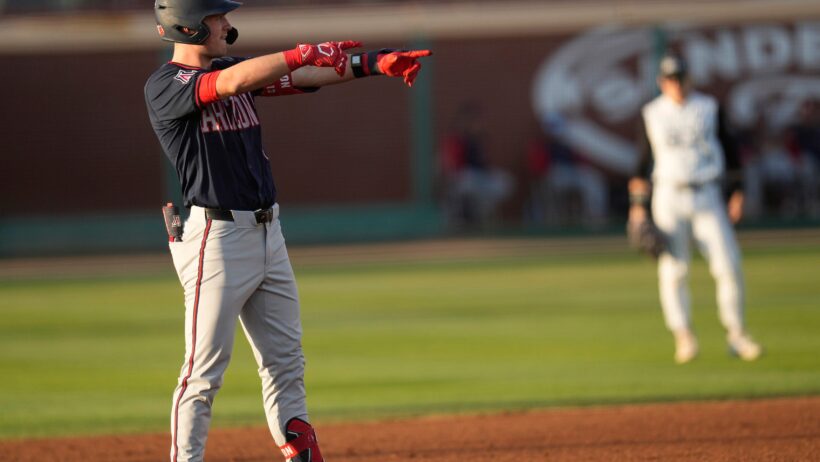 Aaron Walton points at dugout from second base