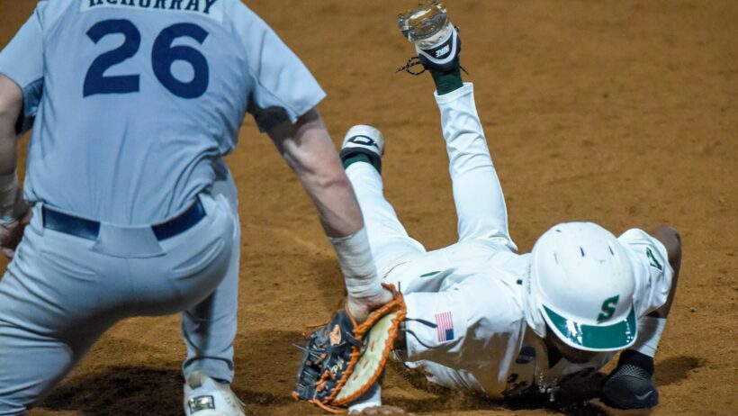 Stetson player ordan Taylor slides into third