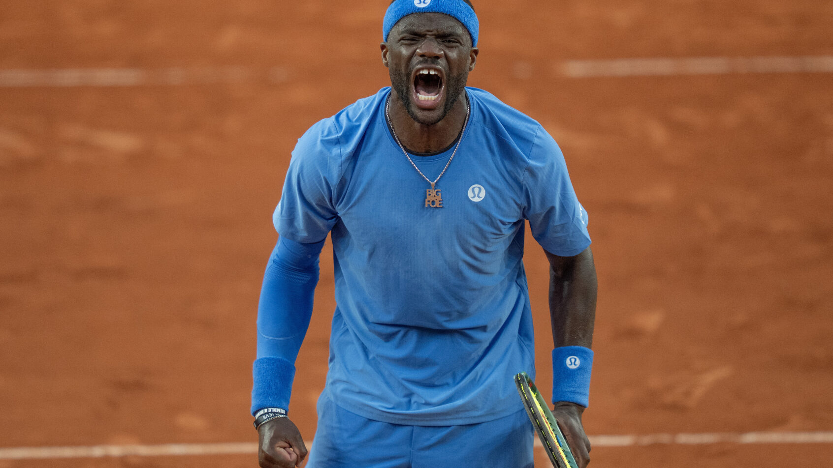 Frances Tiafoe celebrates a win at the French Open.
