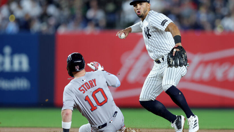 New York Yankees shortstop Oswald Peraza forces out Boston Red Sox shortstop Trevor Story at second base