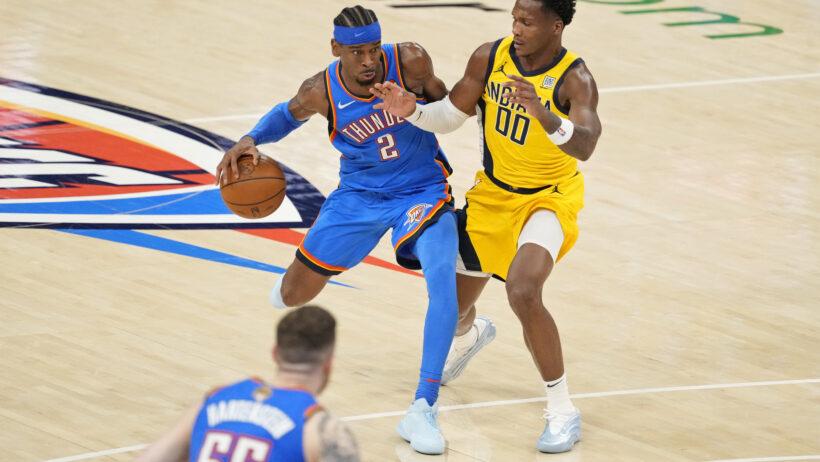 Oklahoma City Thunder guard Shai Gilgeous-Alexander dribbles as Indiana Pacers guard Bennedict Mathurin defends
