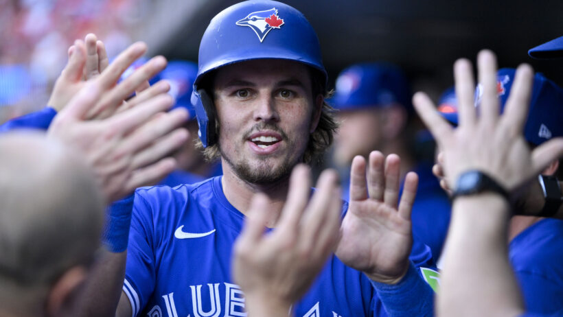 Toronto Blue Jays third baseman Addison Barger high-fiving teammates in the dugout