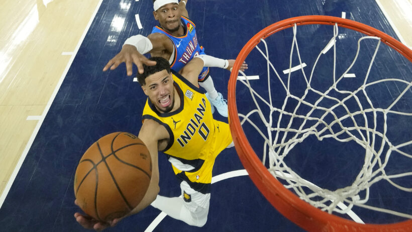 Indiana Pacers guard Tyrese Haliburton shoots a lay-up as Oklahoma City Thunder guard Shai Gilgeous-Alexander tries to block the shot