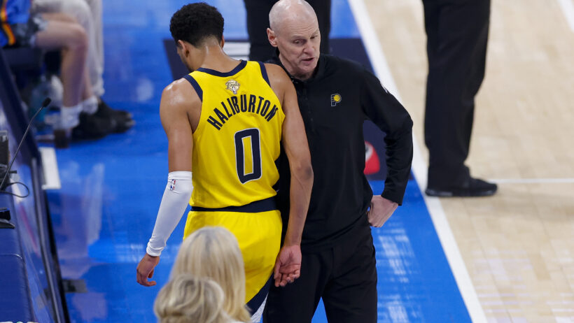 Indiana Pacers guard Tyrese Haliburton talking to coach Rick Carlisle on the sideline