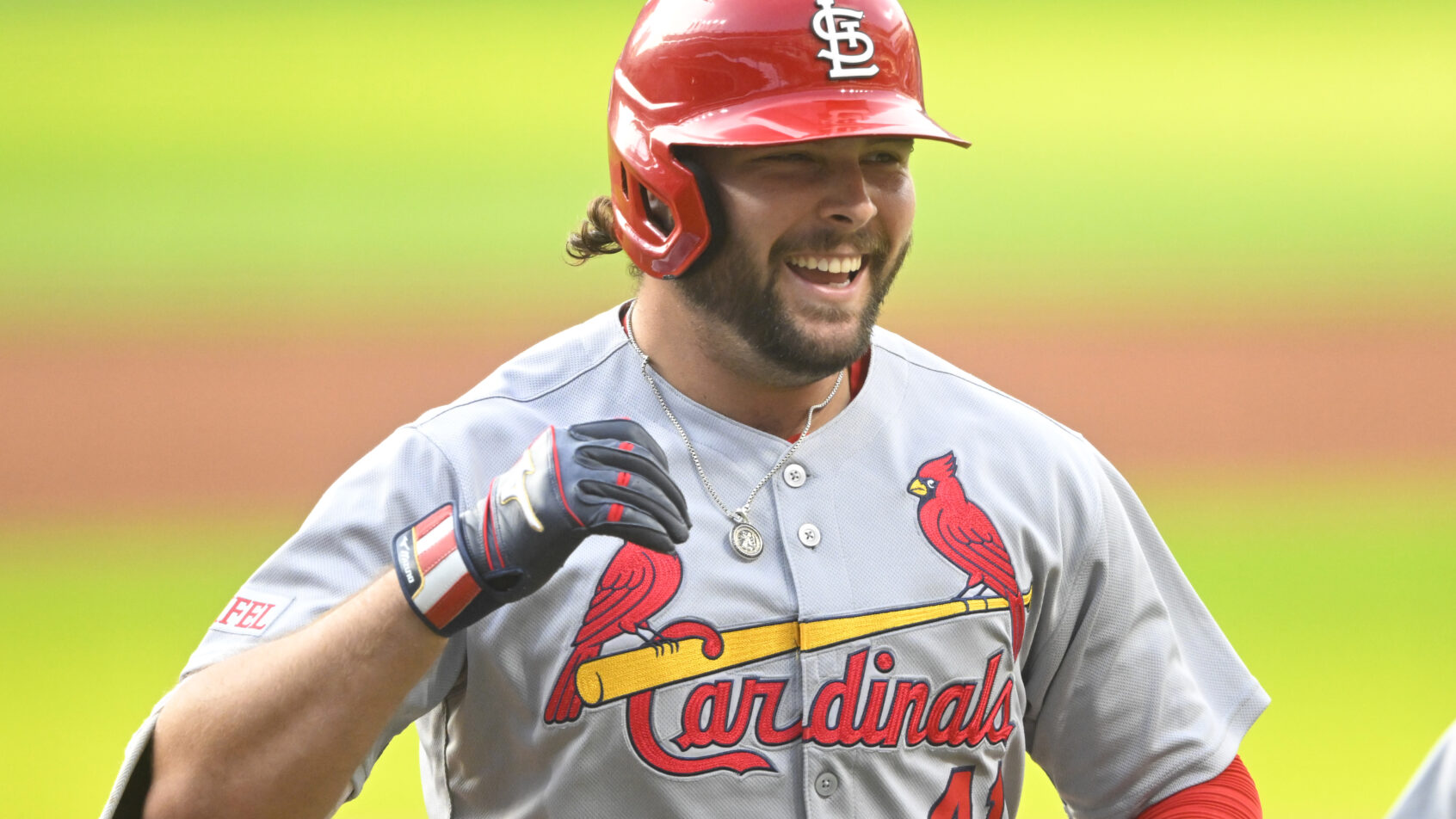 Alec Burleson smiling after hitting a home run