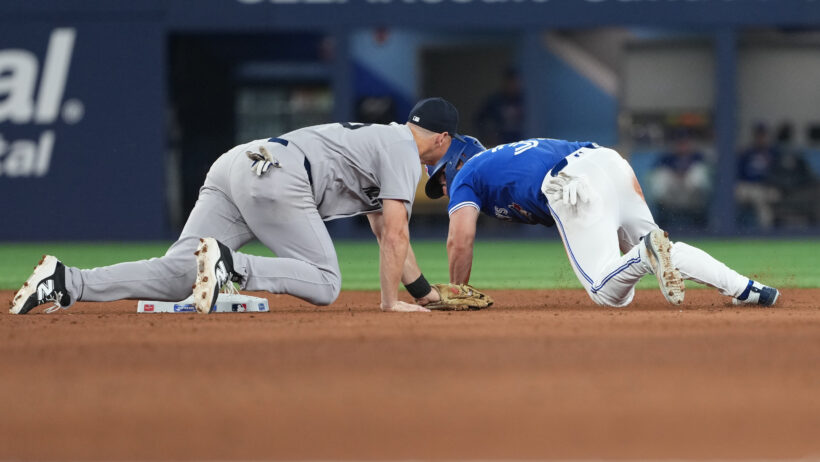 New York Yankees second baseman DJ LeMahieu tags out Toronto Blue Jays left fielder Davis Schneider