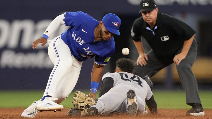New York Yankees left fielder Jasson Dominguez slides into second as Toronto Blue Jays second baseman Leo Jimenez attempts to apply a tag