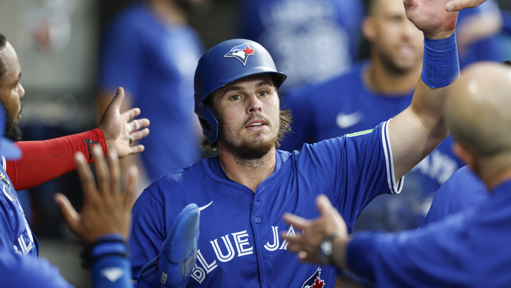 Toronto Blue Jays third baseman Addison Barger celebrates in the dugout with teammates