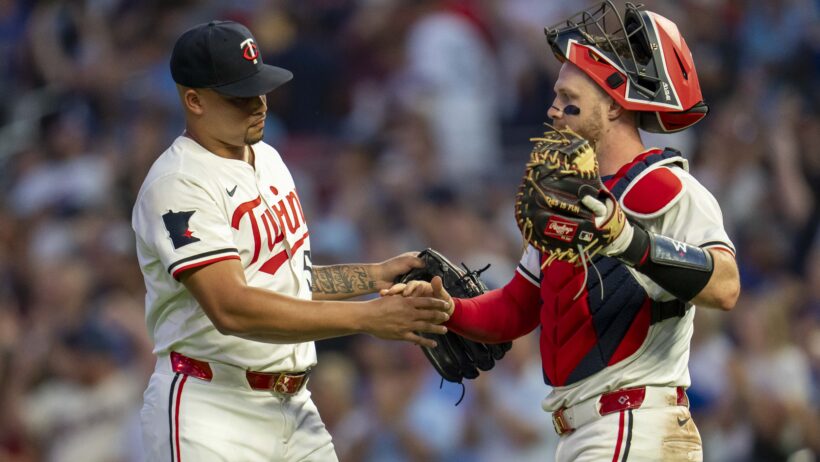 Minnesota Twins relief pitcher Jhoan Duran celebrates with catcher Ryan Jeffers