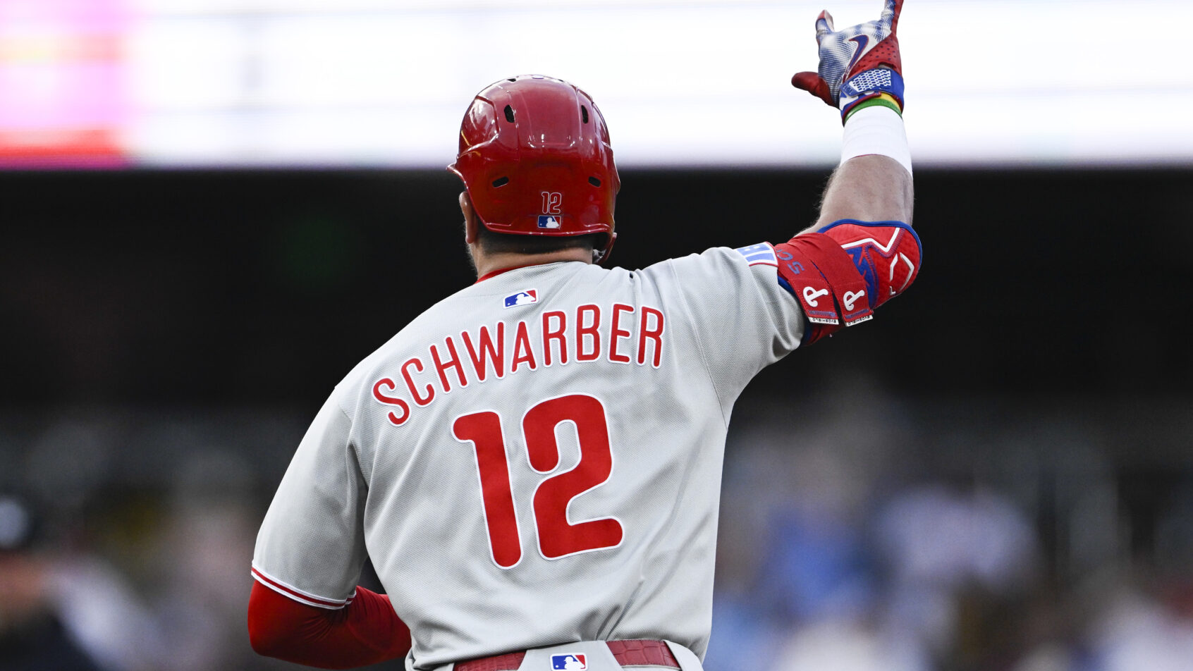Kyle Schwarber with his hand in the air