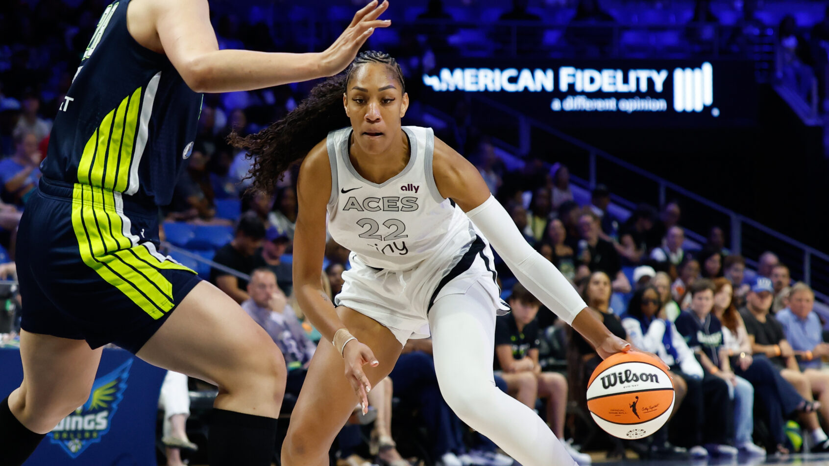 Las Vegas Aces center A'ja Wilson dribbles as Dallas Wings center Li Yueru defends