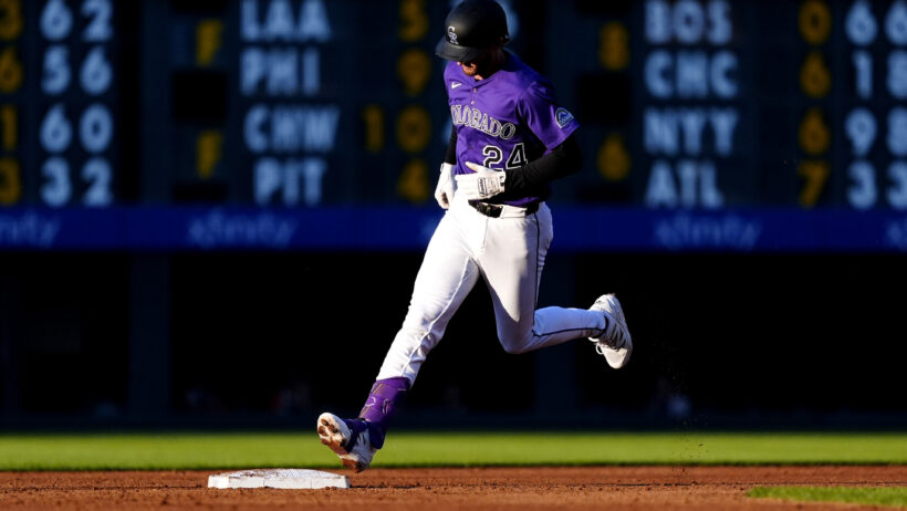 Ryan McMahon rounding the bases after hitting a home run