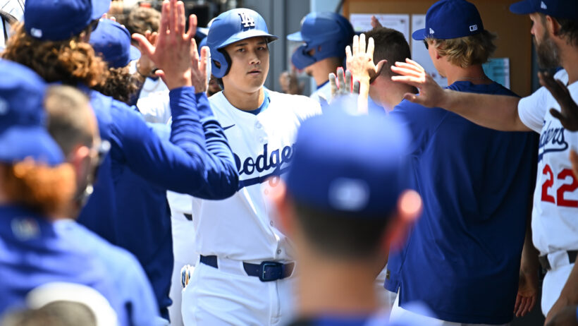 Shohei Ohtani high-fiving LA Dodgers teammates in the dugout