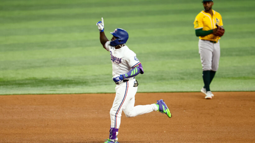 Adolis Garcia rounding the bases after hitting a home run