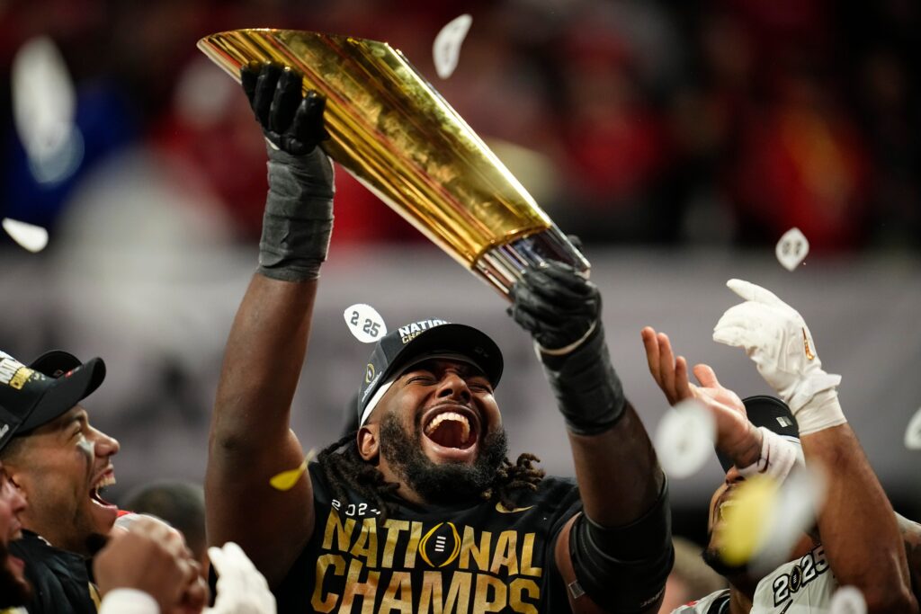 How to bet on the College Football Playoffs. Jeremiah Smith Ohio State WR lifts CFP Trophy.