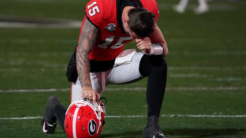 Carson Beck taking a knee