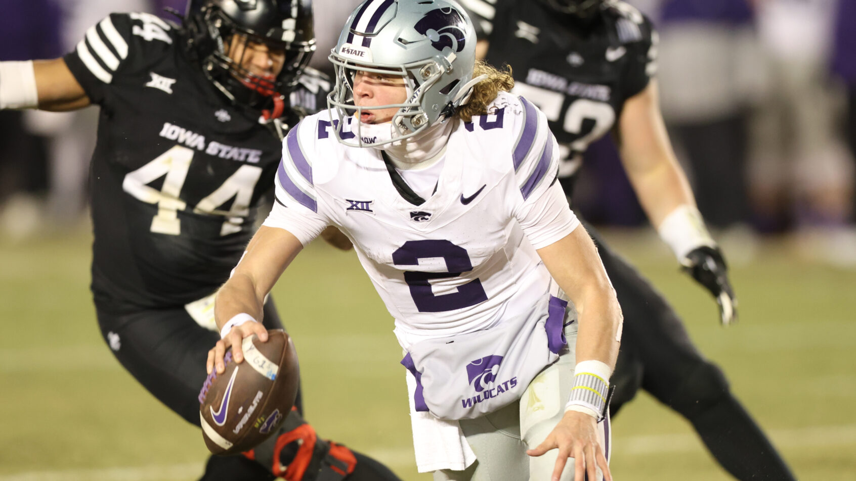 Kansas State Wildcats quarterback Avery Johnson is pressured by Iowa State Cyclones linebacker Jacob Ellis