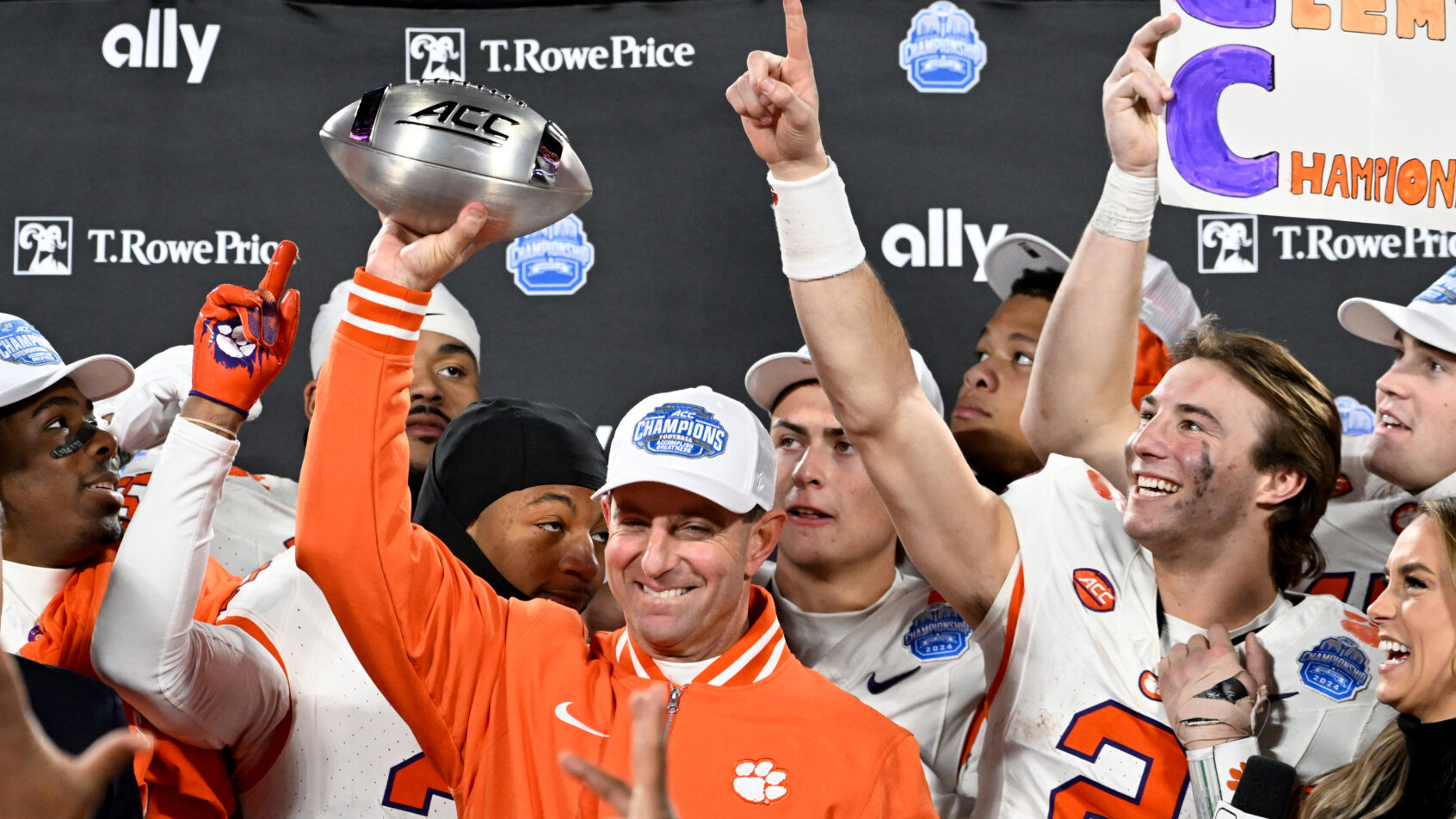 Clemson Tigers head coach Dabo Swinney, quarterback Cade Klubnik and teammates celebrate after winning the ACC Championship game